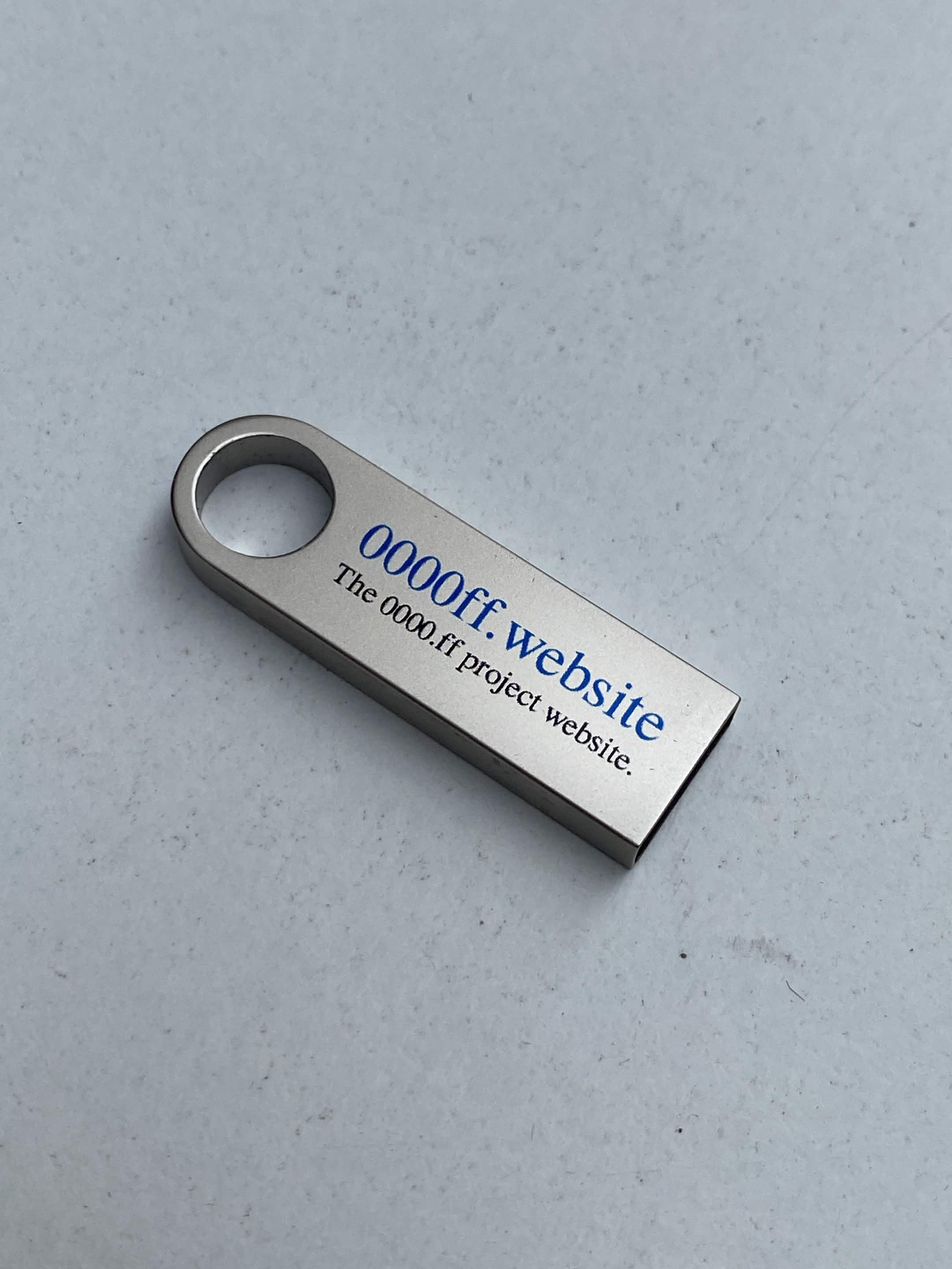 USB drive labeled 0000ff.website